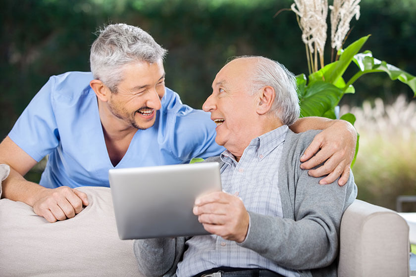 Veteran enjoying friendly conversation with caregiver, highlighting emotional support and companionship.