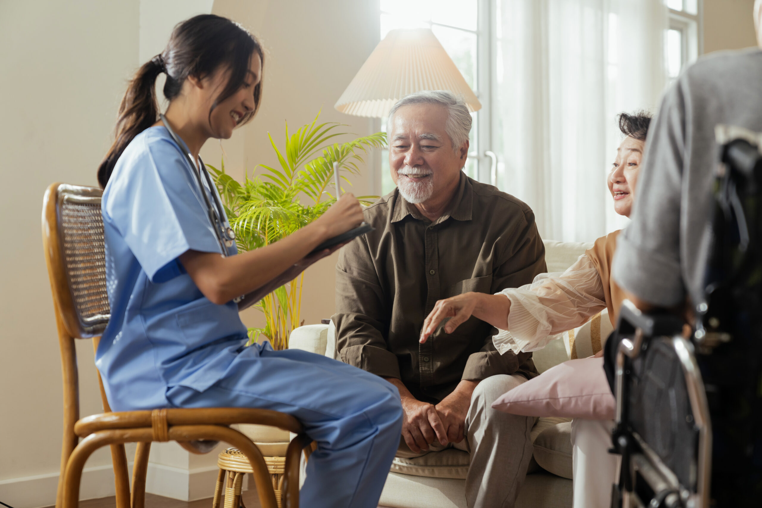 Caregiver supporting senior patient during home recovery after transfusion